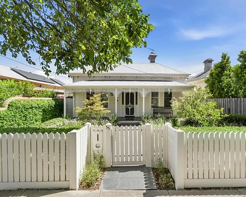 Charming Victorian home with a white picket fence, landscaped gardens, heritage façade and beautifully preserved period details in a sought-after streetscape.