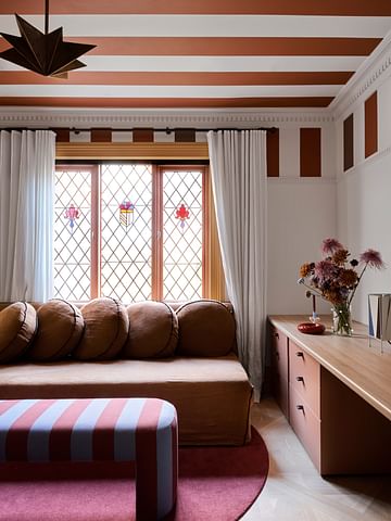 A layered interior with bold graphic stripes and rich colour