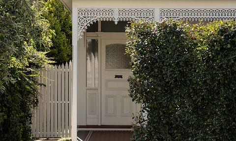 Inner Melbourne heritage home with white iron details and lush hedge